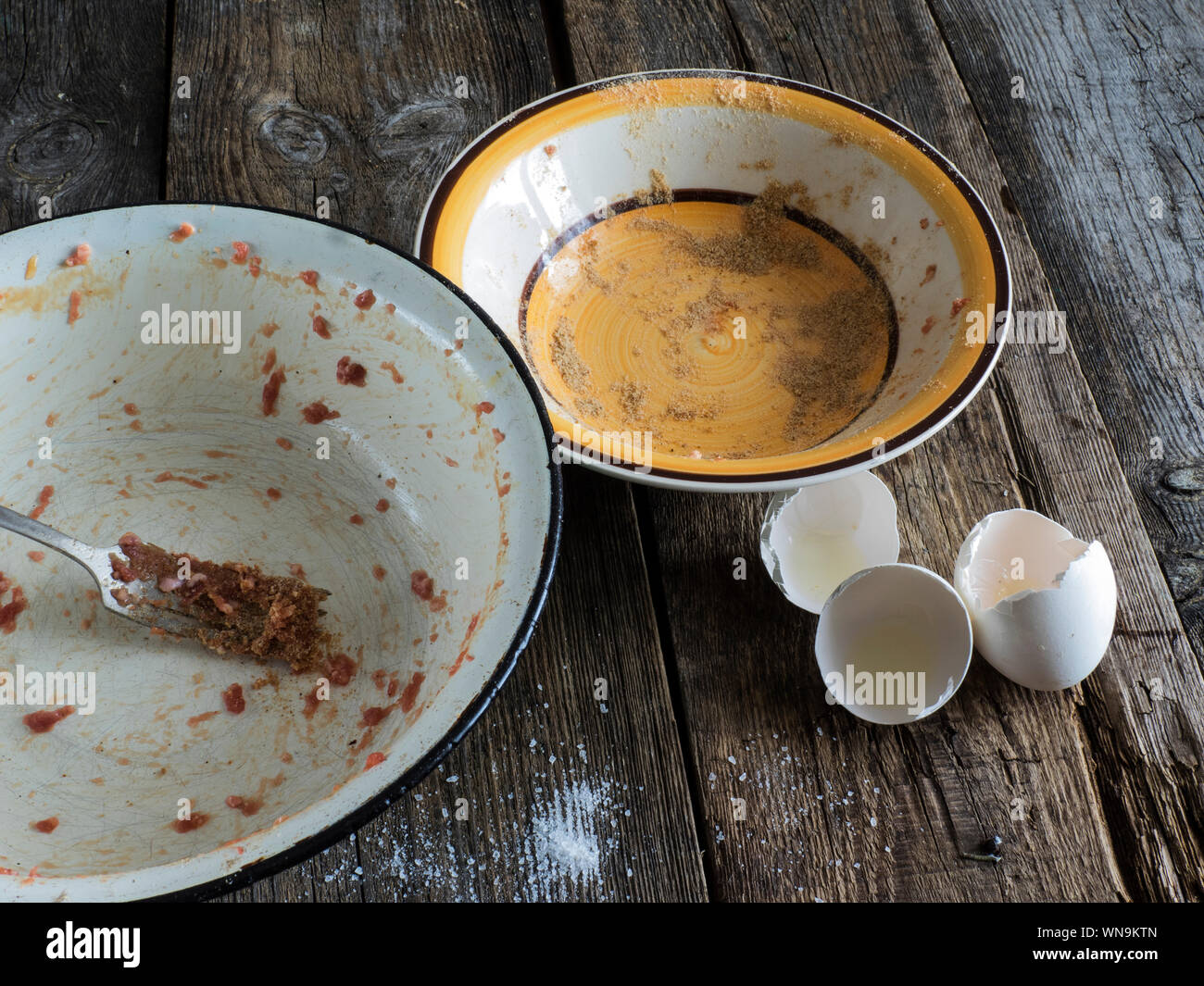 Leftovers In Plate By Eggshells At Wooden Table Stock Photo