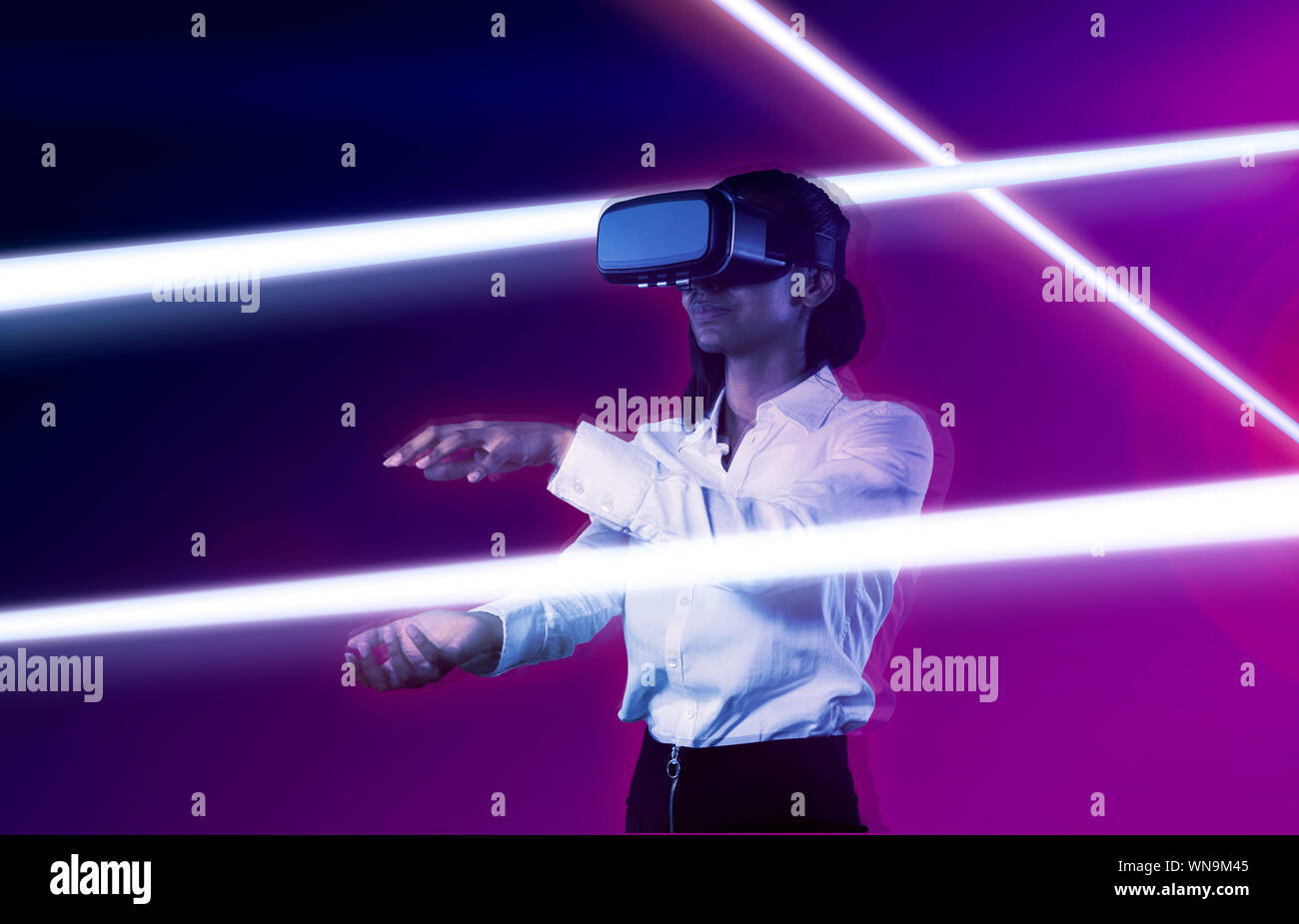 Composite image of woman using virtual reality headset. Stock Photo