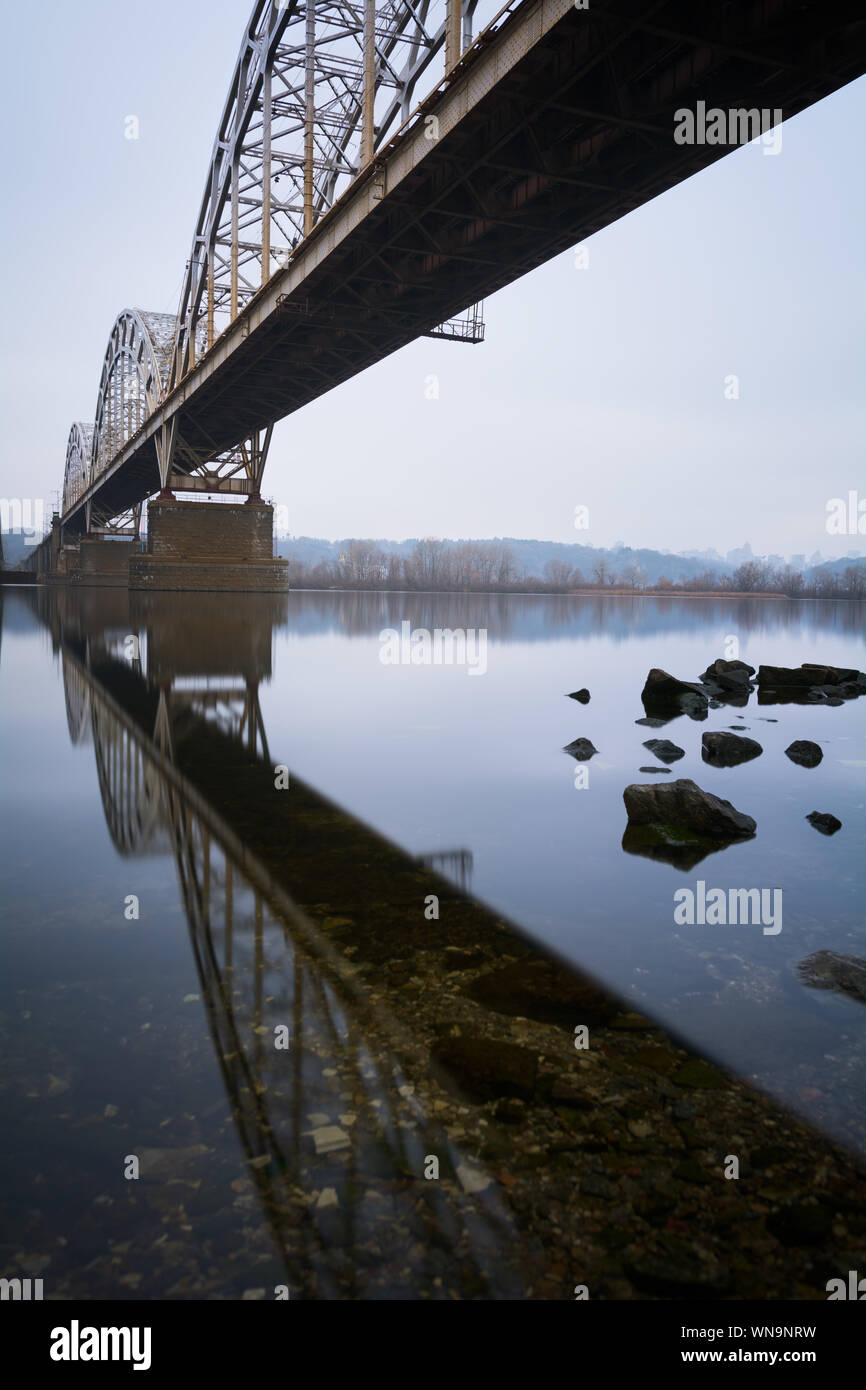 Railway Bridge And Reflection Over River Stock Photo