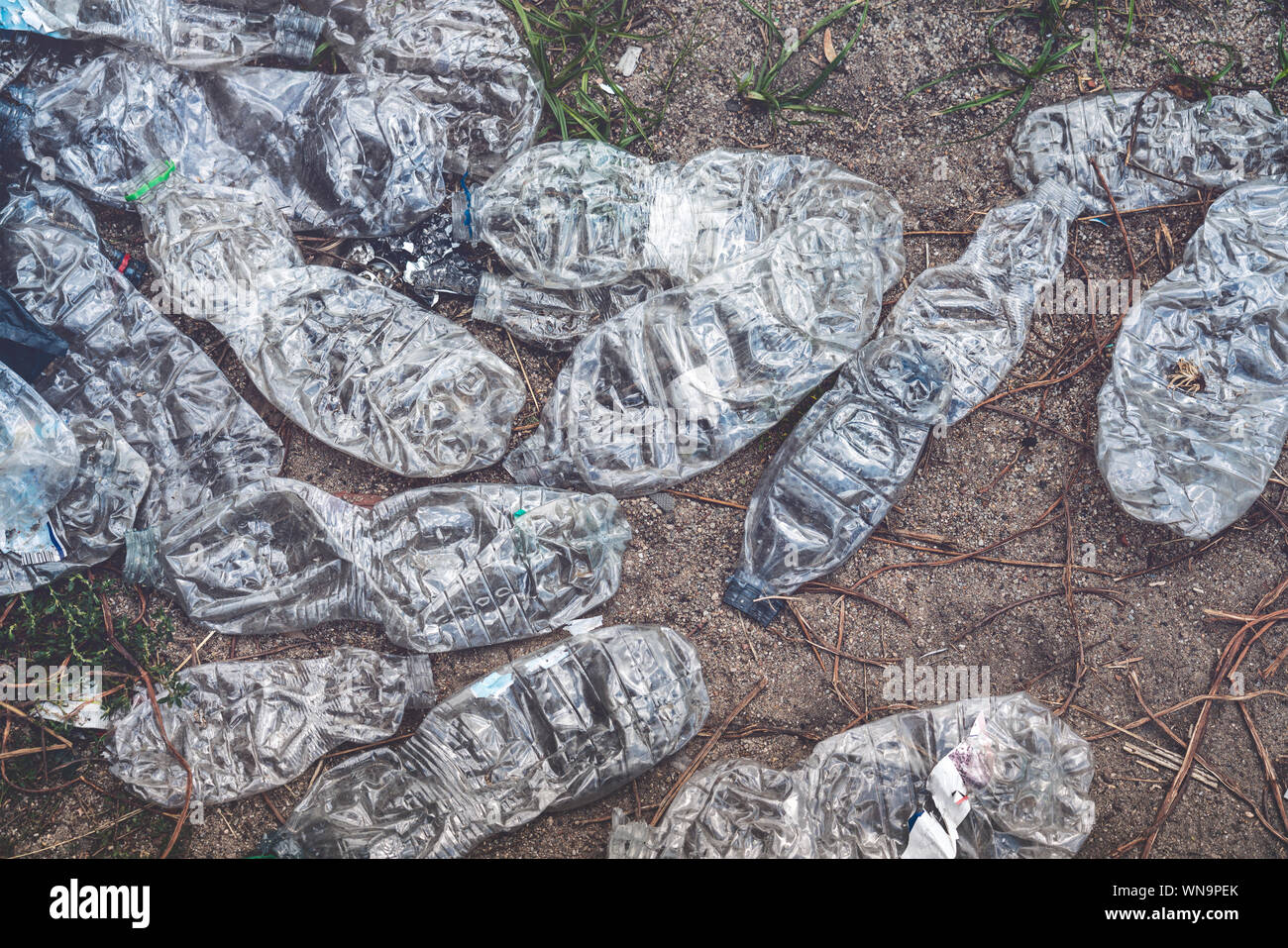 old crushed plastic bottles lying on the floor Stock Photo