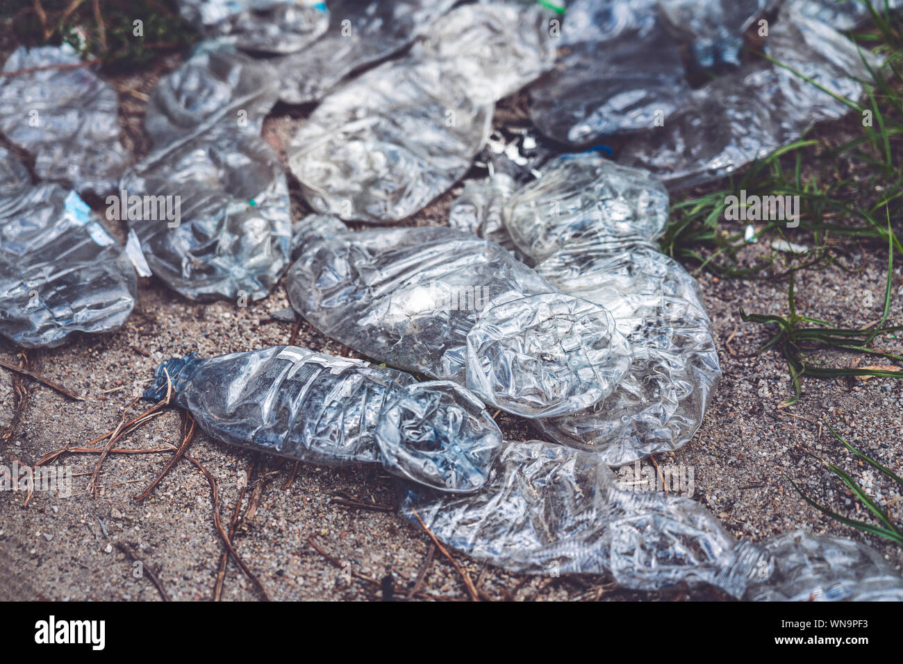old crushed plastic bottles lying on the floor Stock Photo