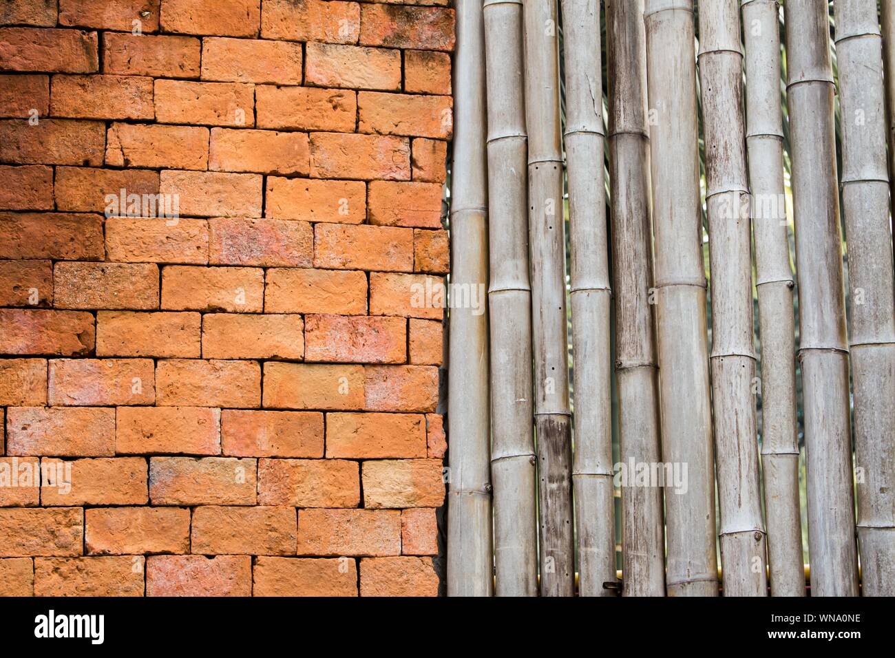 Backgrounds and pattern of ancient brick walls orange and old bamboo