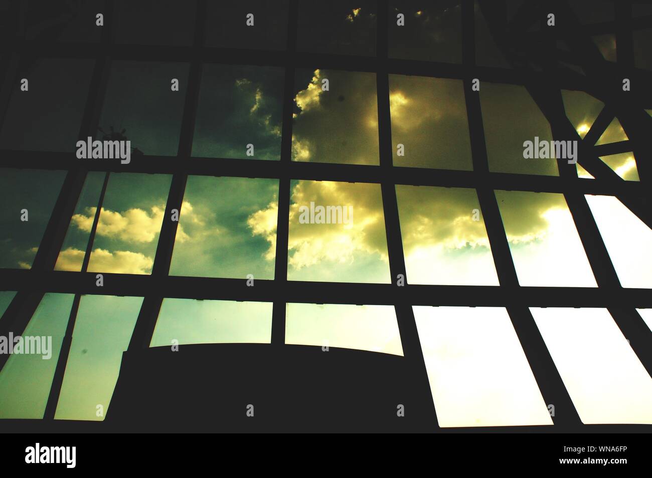 Low Angle View Of Silhouette Glass Window Against Sky At Dusk In Narita Airport Stock Photo