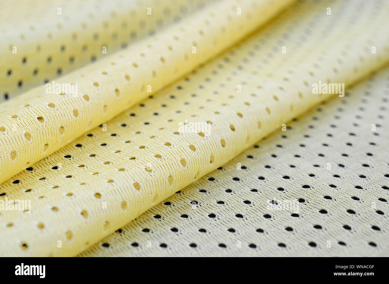 Yellow mesh sport wear fabric textile pattern background. Yellow color football  jersey clothing fabric texture sports wear. Breathable porous porifero  Stock Photo - Alamy