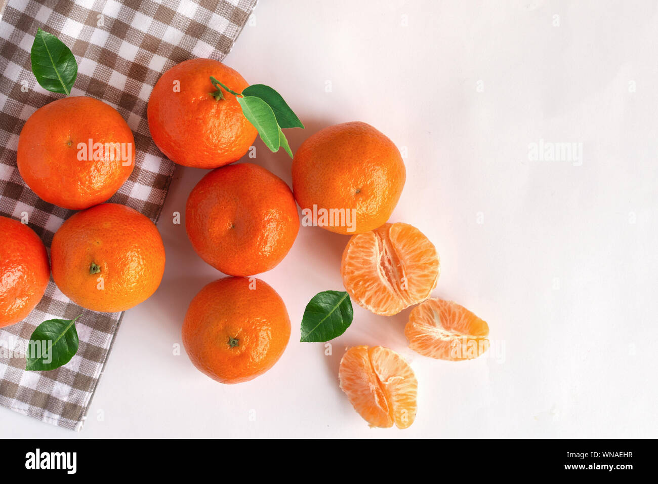 Mandarins fruits top view on white decorated table background. Healthy