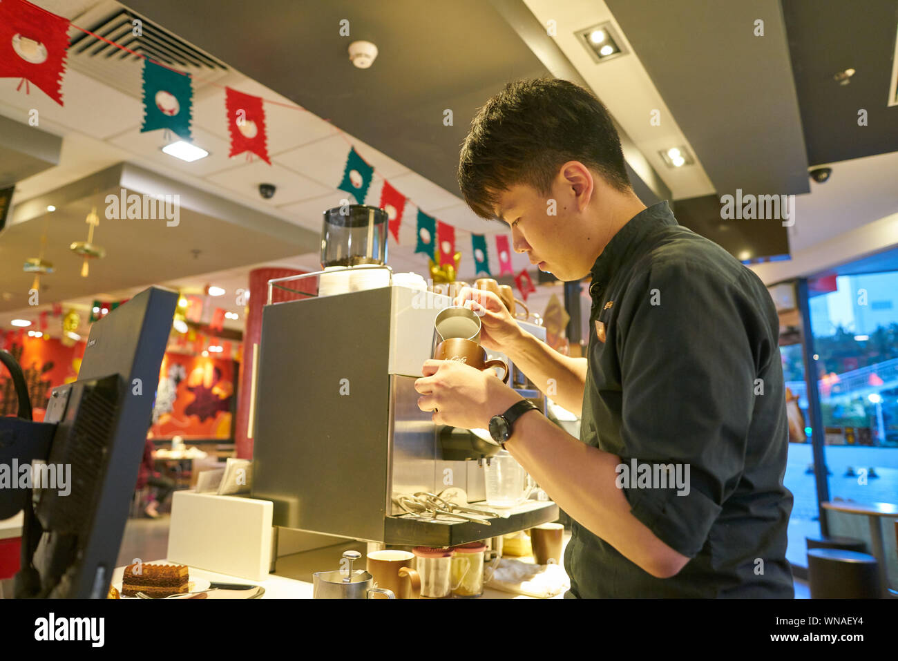 Mccafe Worker SHENZHEN, CHINA - CIRCA FEBRUARY, 2019: worker prepare coffee at McCafe ...