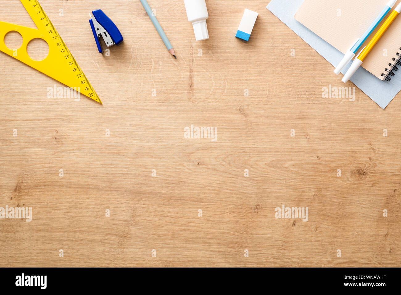 Top down view of school supplies and lunch on a light background