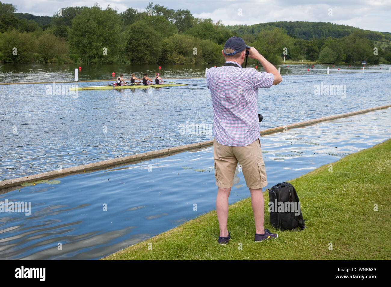 A spectator watches the races from the river bank at the Henley Womens