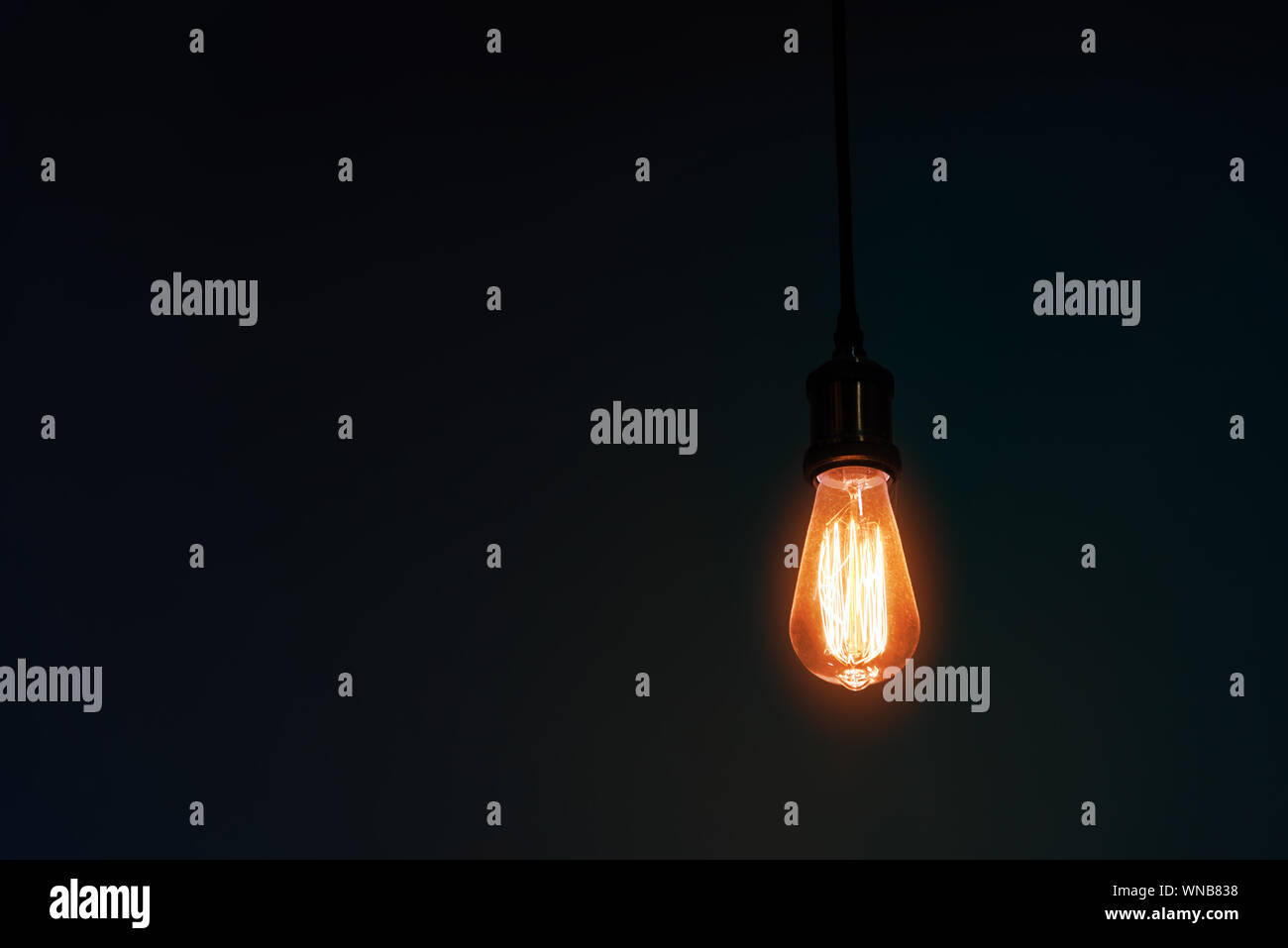 Illuminated Oldfashioned Light Bulb In Darkroom Stock Photo Alamy