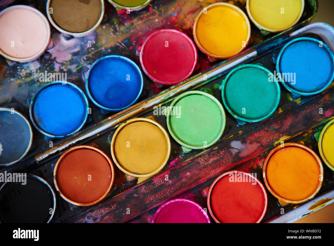 Close-up Of Watercolor Paint And Brush Stock Photo