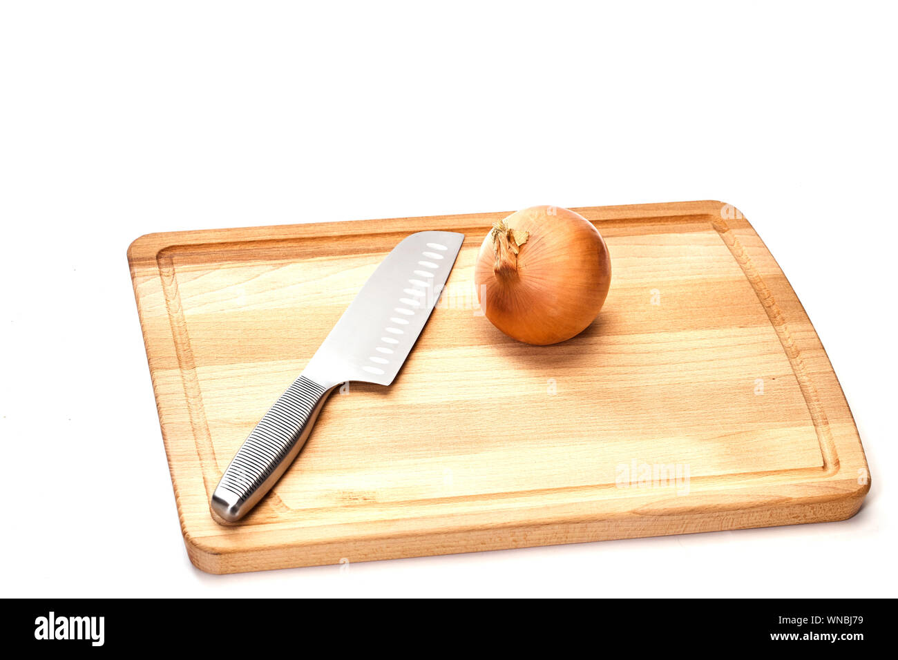 Close-up Of Onion On Cutting Board Over White Background Stock Photo