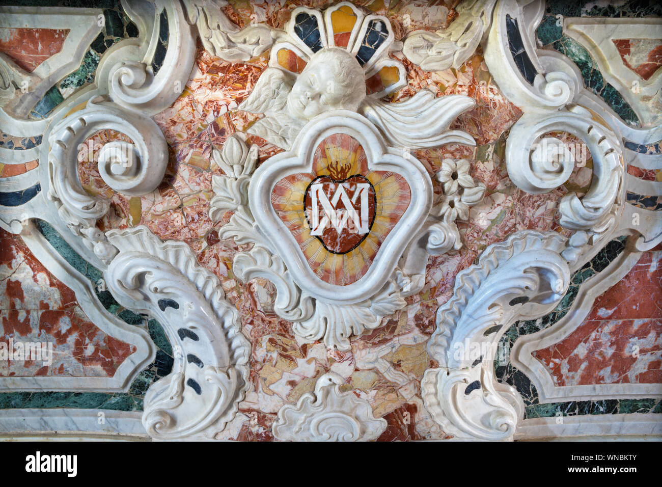 TAORMINA, ITALY - APRIL 9, 2018: The detail of marble baroque altar with the marianic initials in chruch Chiesa Madonna della Rocca from 18. cent. Stock Photo