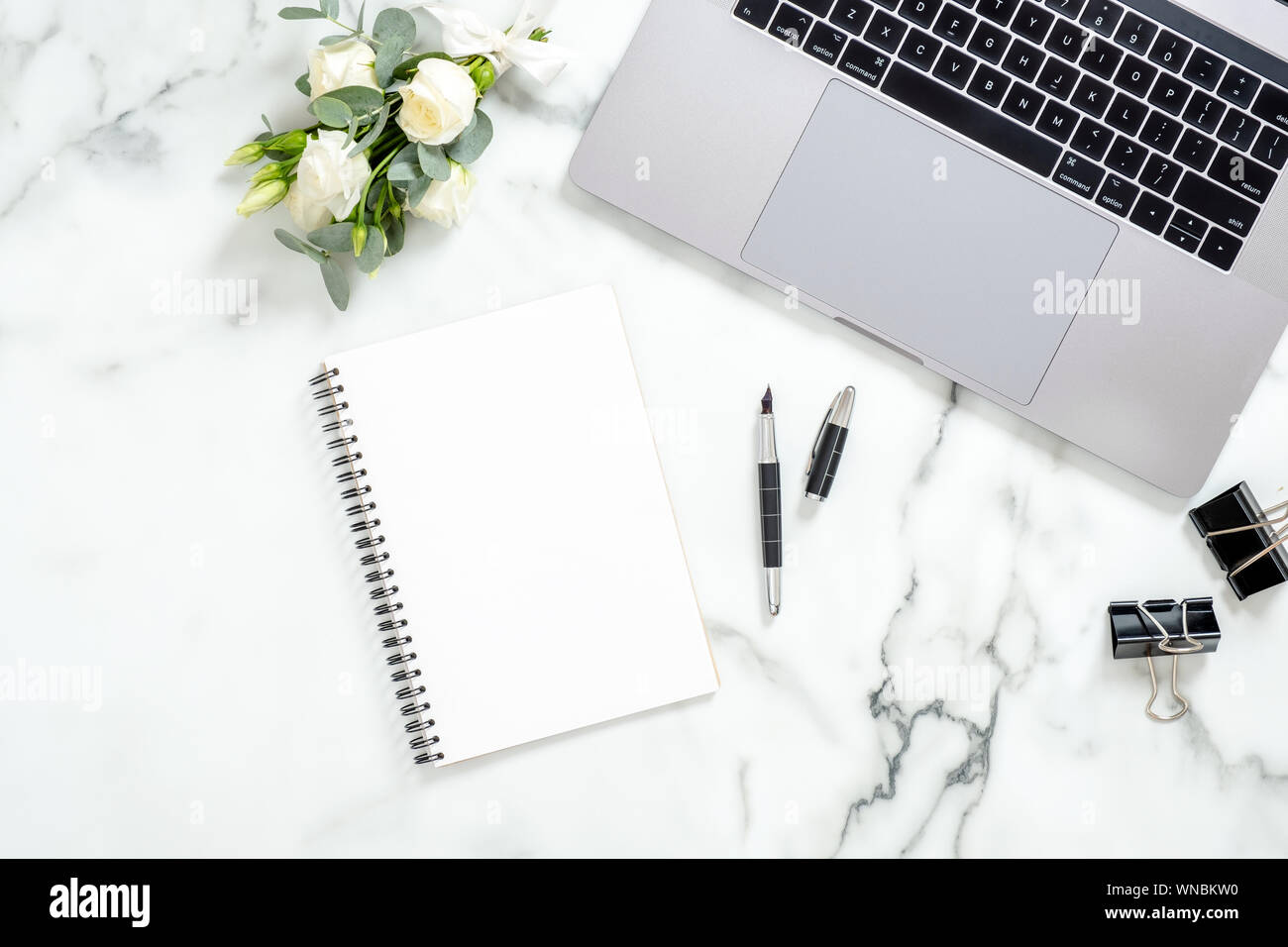 Modern home office desk workspace with blank paper notebook, white flowers  and feminine accessories on marble background. Flat lay, top view, overhead  Stock Photo - Alamy