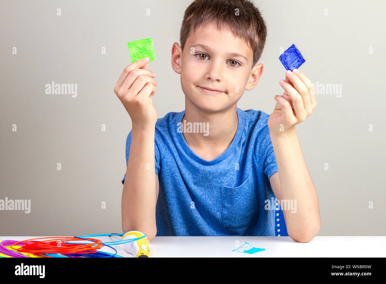Child creating with 3d printing pen new object Stock Photo