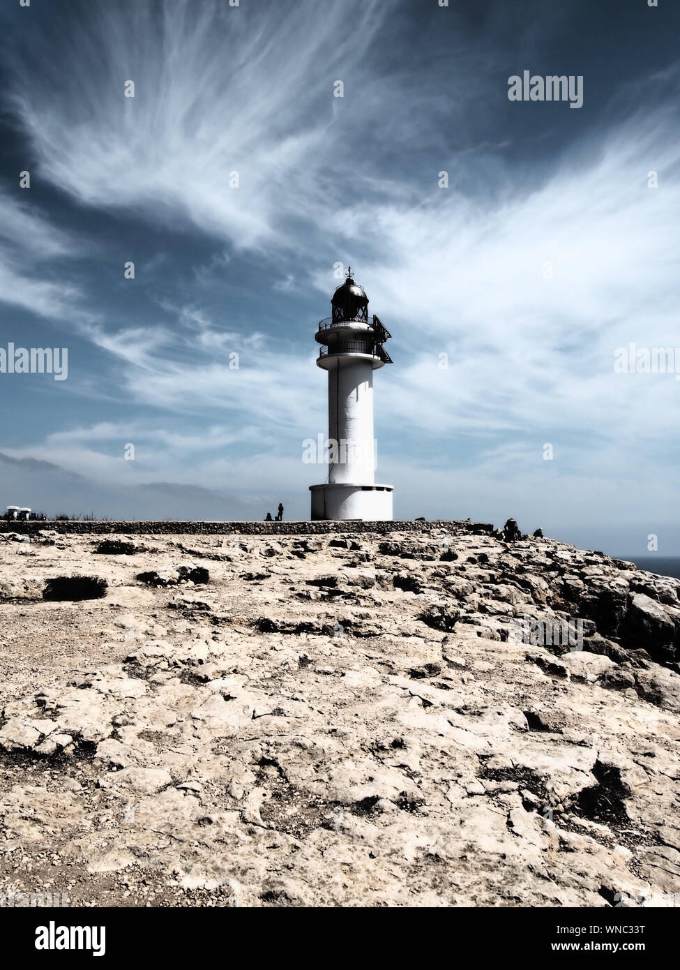 Low Angle View Of Lighthouse At Harbor Against Cloudy Sky Stock Photo