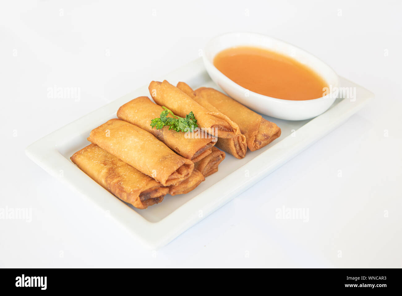 Chinese fried spring rolls served with a tomato spicy sauce Stock Photo