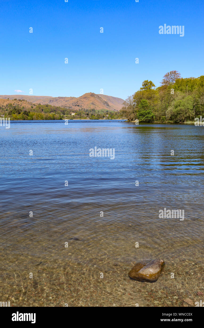 The beautiful serene Lake Grasmere, which feeds into the River Rothay, near Ambleside, lake District, Cumbria, United Kingdom Stock Photo