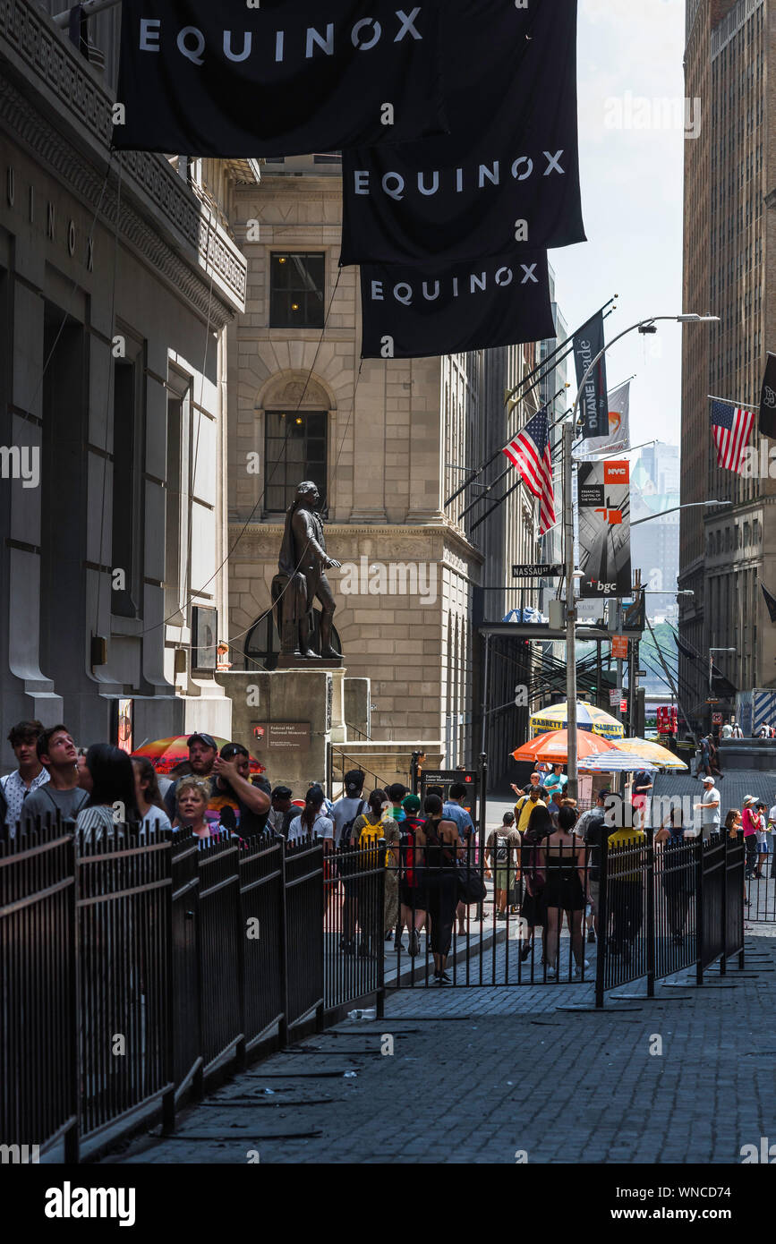 Wall Street New York, view in summer of tourists entering / leaving Wall Street, Lower Manhattan, Financial District, New York City, USA Stock Photo