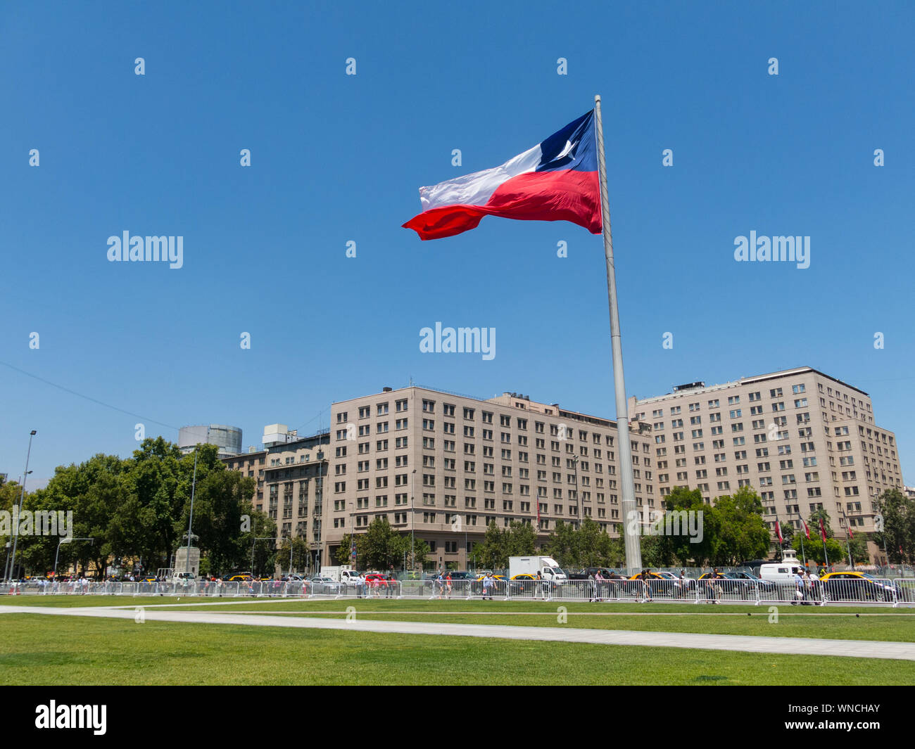 SANTIAGO DE CHILE, CHILE - JANUARY 26, 2018: Chileans walking near the giant flag on Avenida La Alameda with the citizenship Square, in downtown Santi Stock Photo