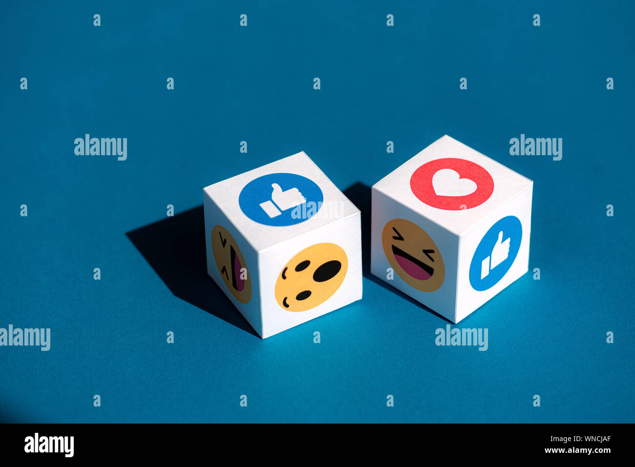 A paper cubes with printed emojis from Facebook Messenger, one of the biggest and world-famous social network. Stock Photo