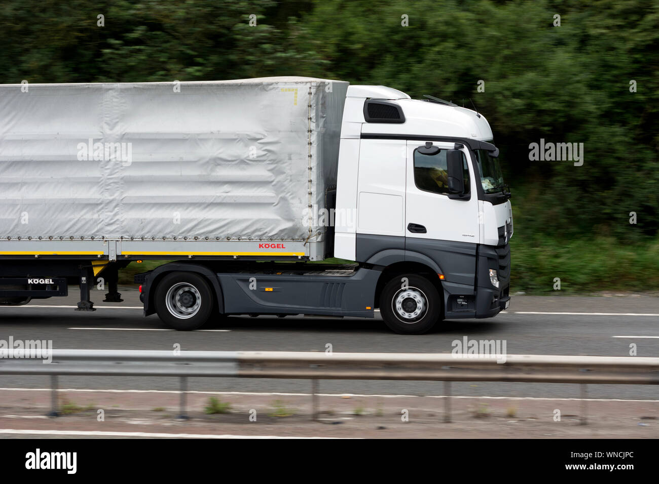 A Mercedes articulated lorry on the M40 motorway, Warwickshire, England, UK Stock Photo