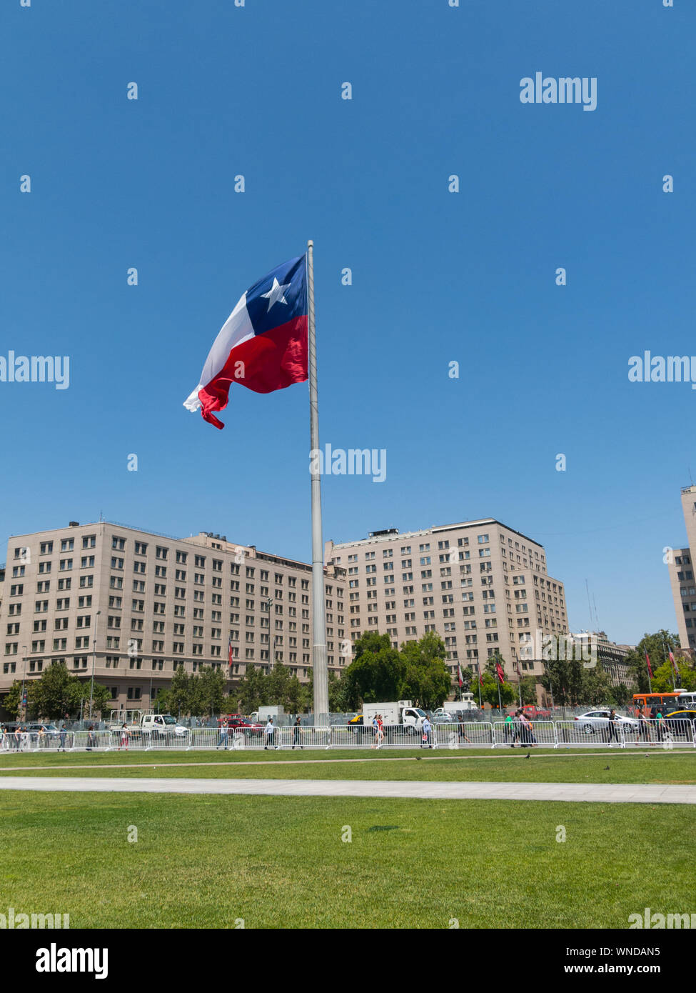 SANTIAGO DE CHILE, CHILE - JANUARY 26, 2018: Chileans walking near the giant flag on Avenida La Alameda with the citizenship Square, in downtown Santi Stock Photo
