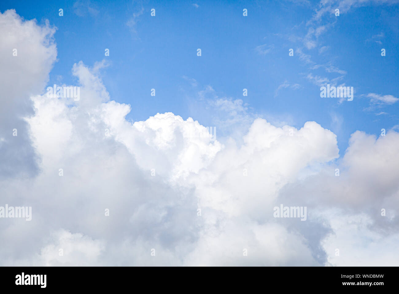 Stunningly blue sky with lots of clouds of different white and gray on ...