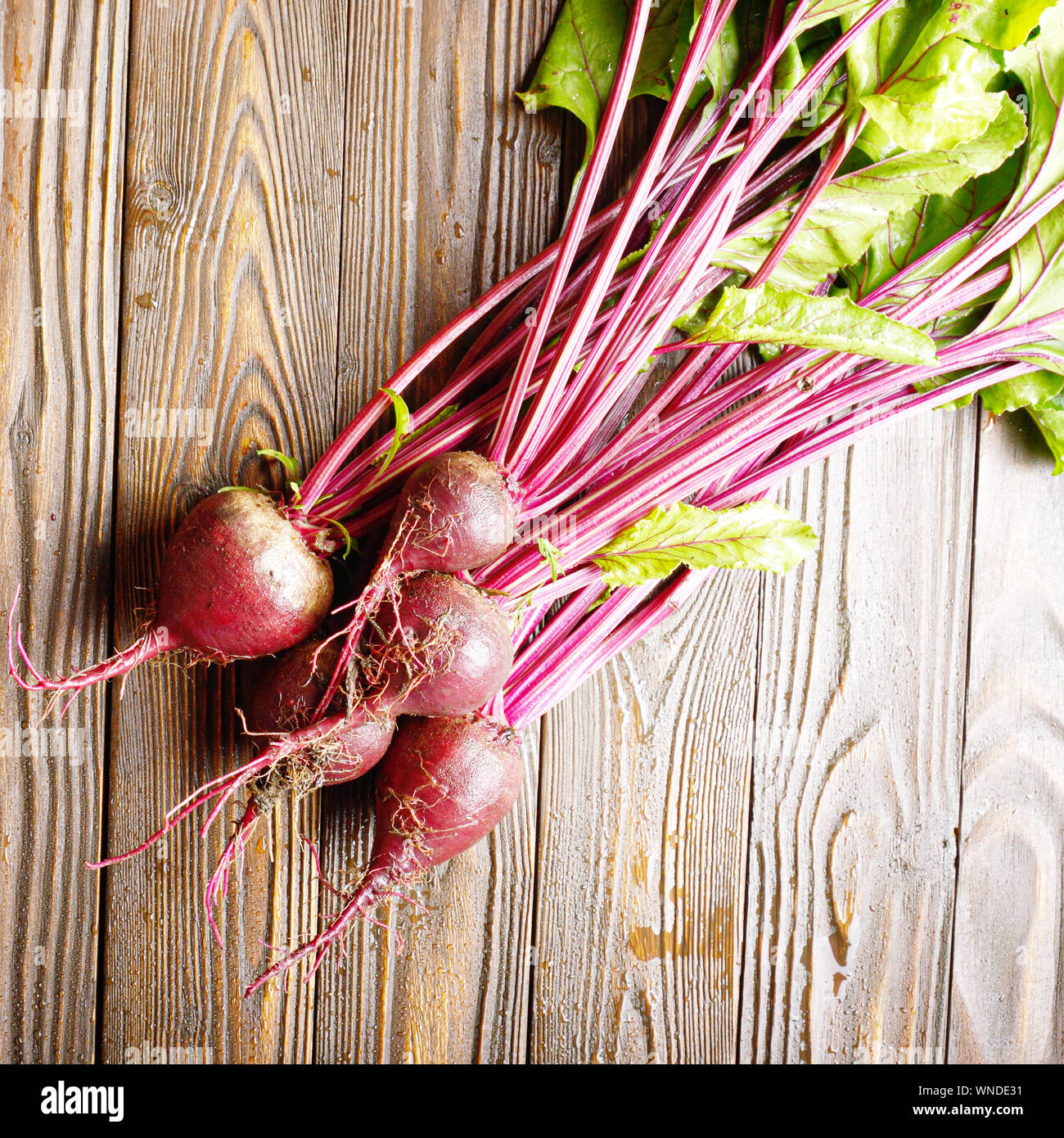 Top view at Fresh organic beetroots on kitchen wooden rustic table Stock Photo