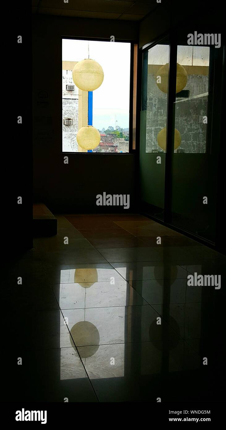 Chinese Lanterns Hanging In Window Reflected On Flooring Stock