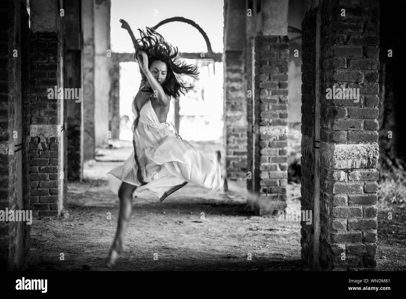 A girl dancing in a abandoned building. Stock Photo
