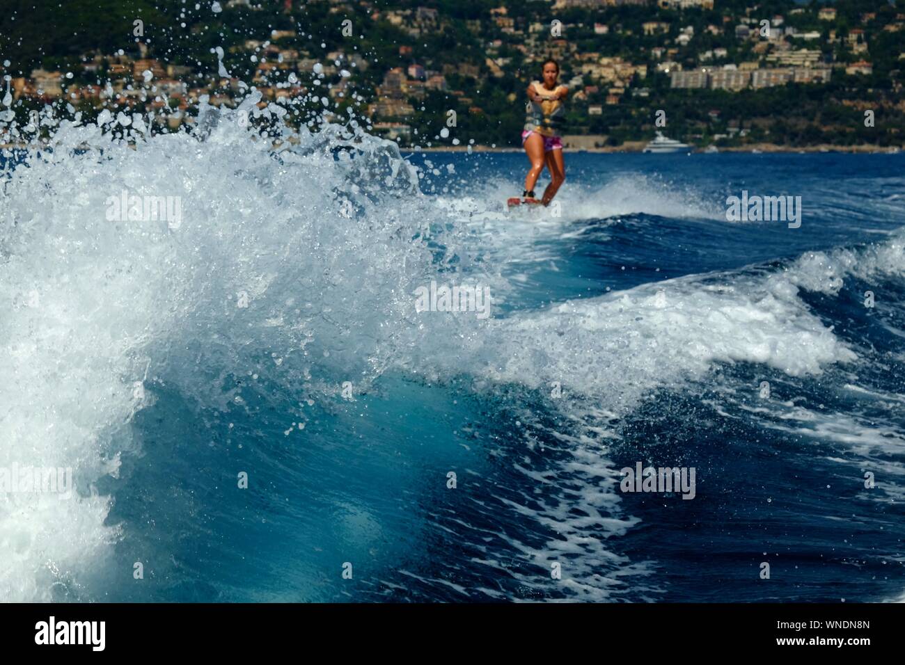 Woman Wakeboarding In Sea Stock Photo