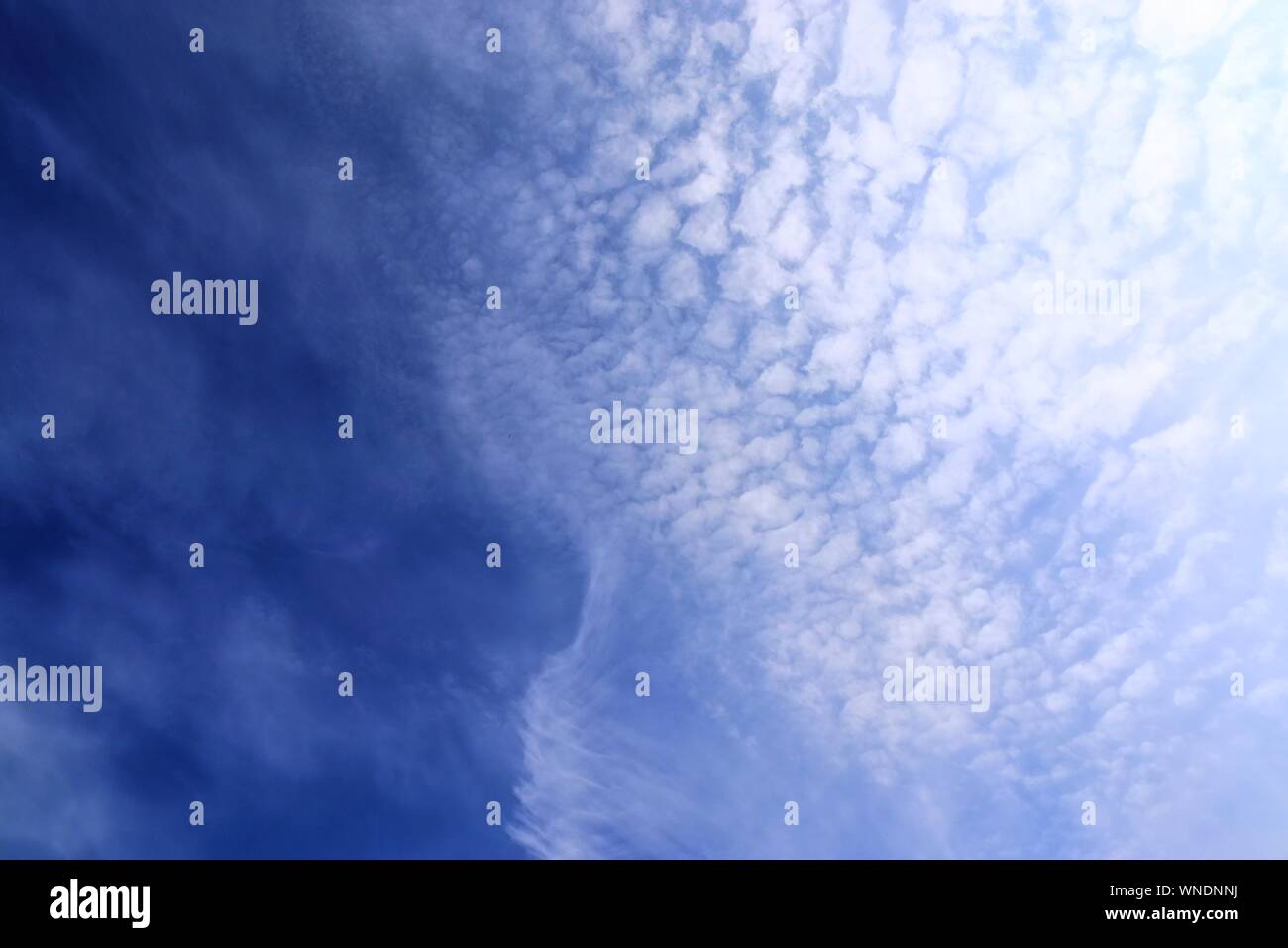 Dramatic and fluffy white clouds on a deep blue summer sky Stock Photo ...