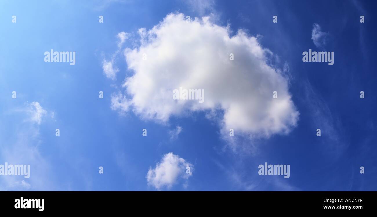 Dramatic and fluffy white clouds on a deep blue summer sky Stock Photo ...
