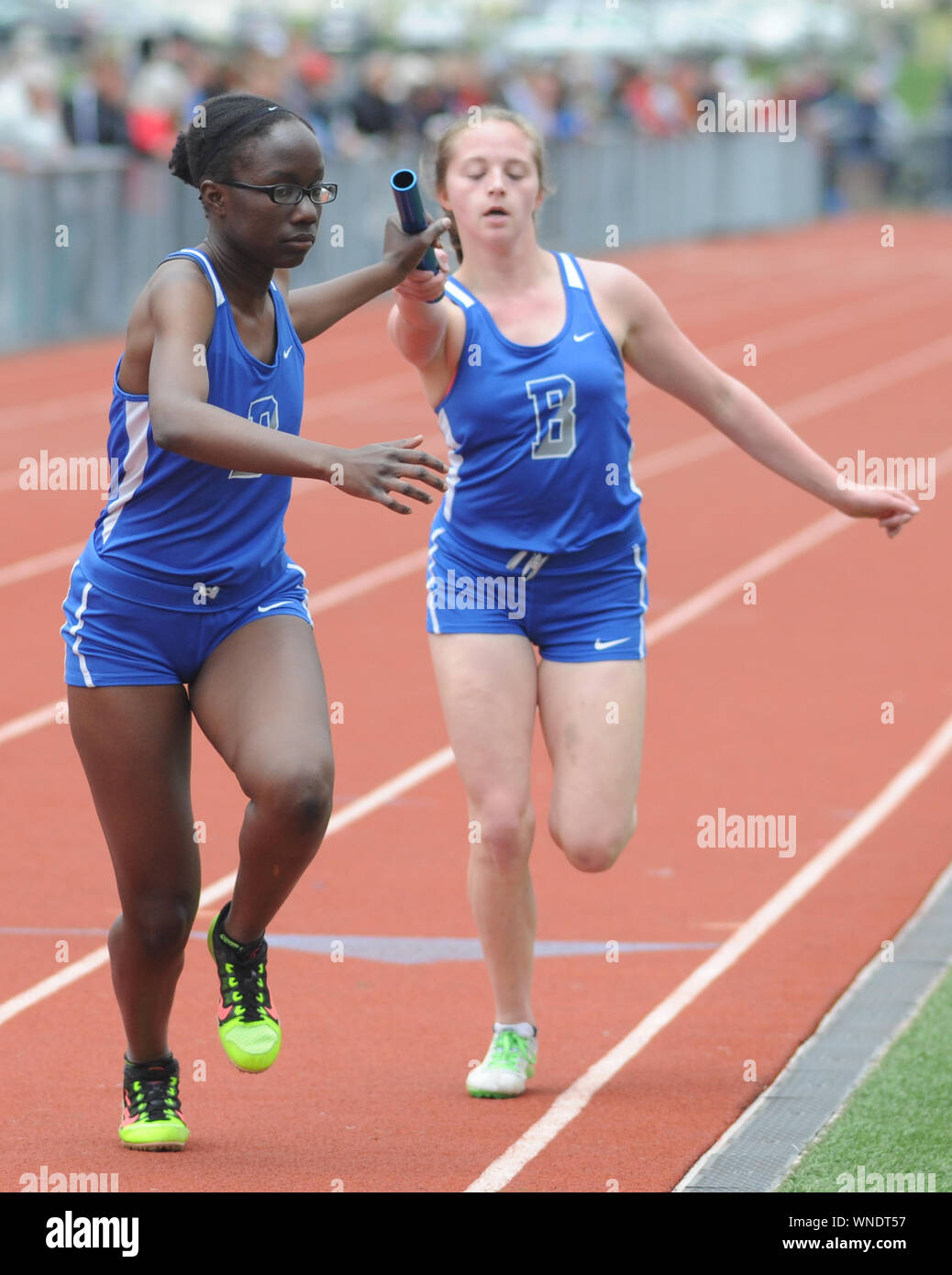 Bensalem's Joy Senkungo (left) and Tori Reid compete in the 4 x 100 relay during the Jim Kelly Invitational Saturday April 15, 2017 in Horsham, Pennsy Stock Photo