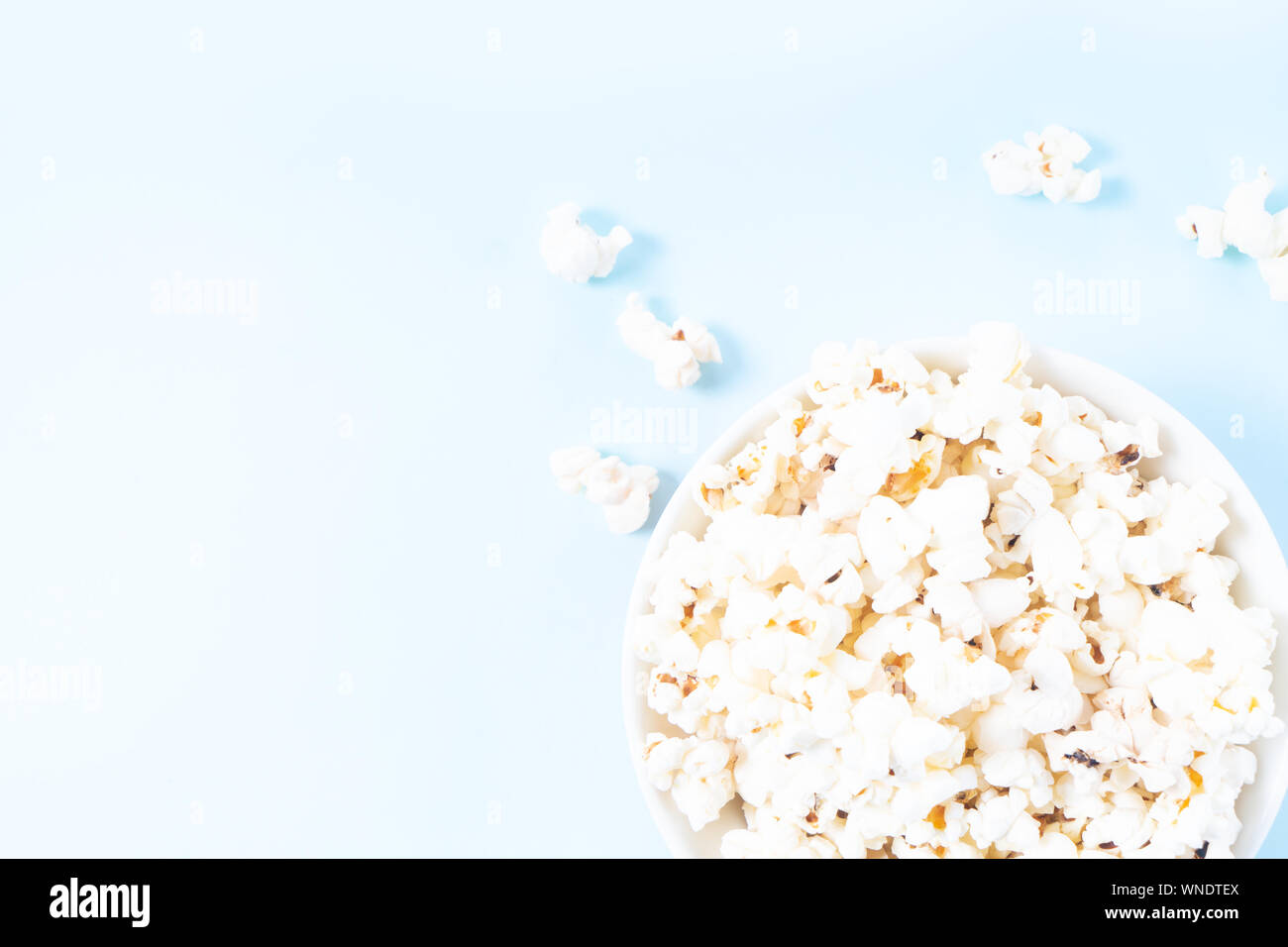 Scattered popcorn over yellow background Stock Photo - Alamy