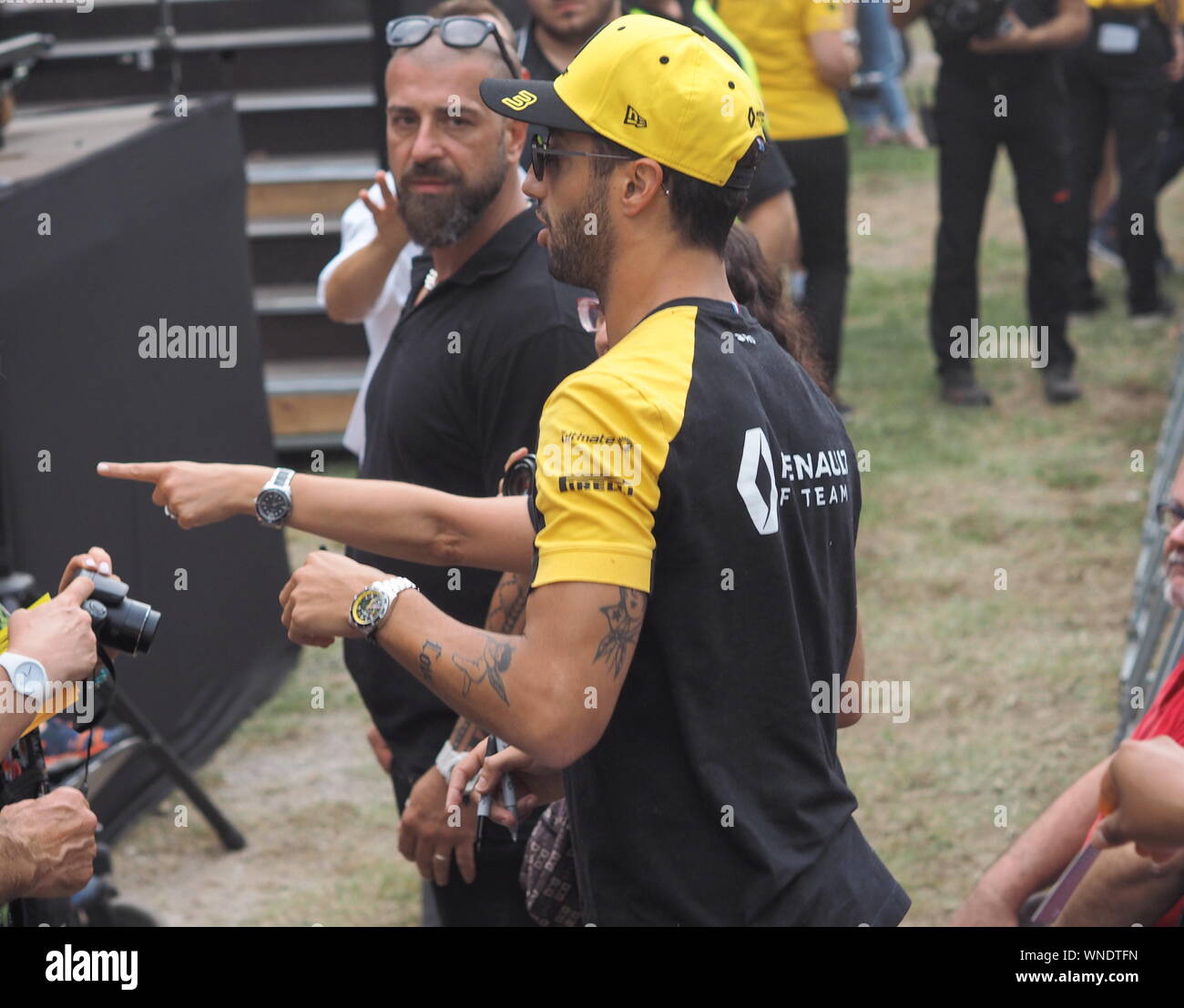 Monza, Italy 5 September 2019: Daniel Ricciardo is among his fans and givings autograph in Monza circuit paddock. Stock Photo