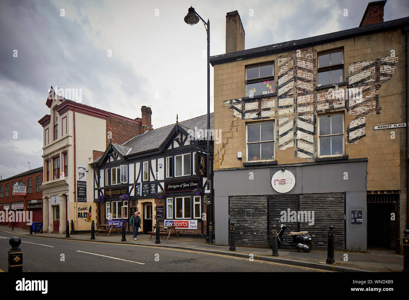 Historic market area The Cooked Hat pub and NS2 shop with painted tudor style Stock Photo