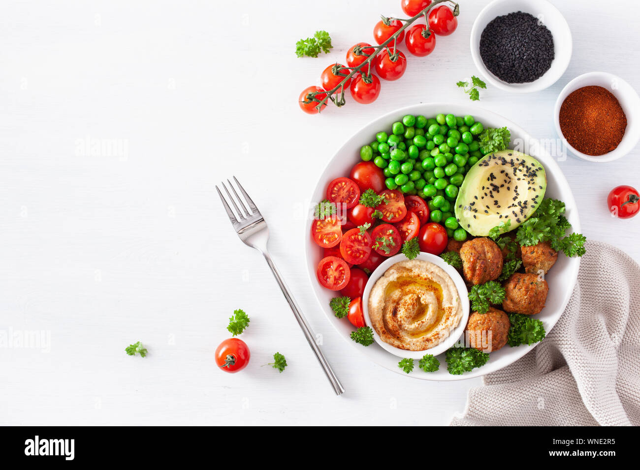 healthy vegan lunch bowl with falafel hummus tomato avocado peas Stock Photo