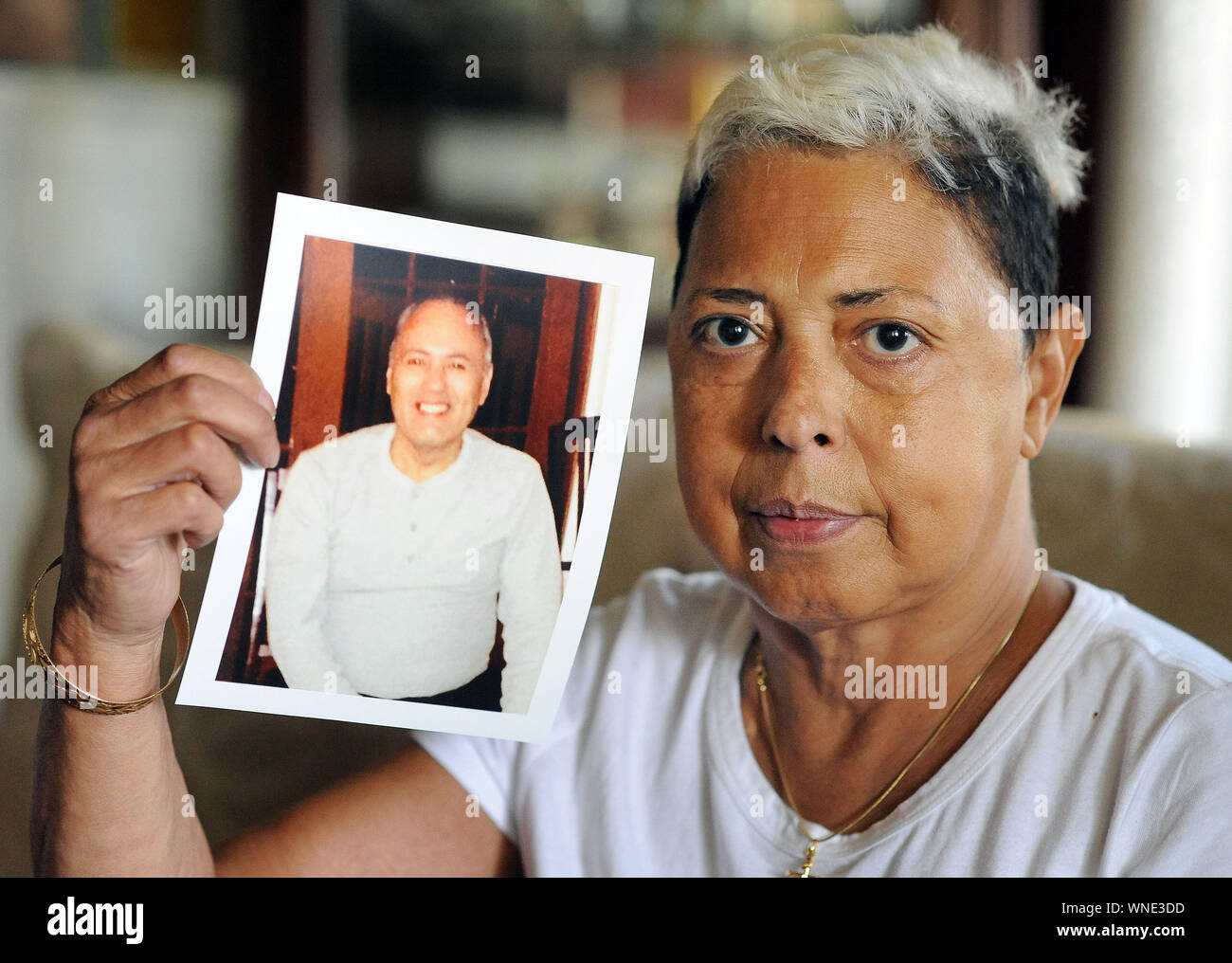 Miriam Rodriguez, of Bethlehem, Pennsylvania holds a photograph of her brother Frank Rodriguez in her living room Tuesday, September 26, 2017 in Bethl Stock Photo