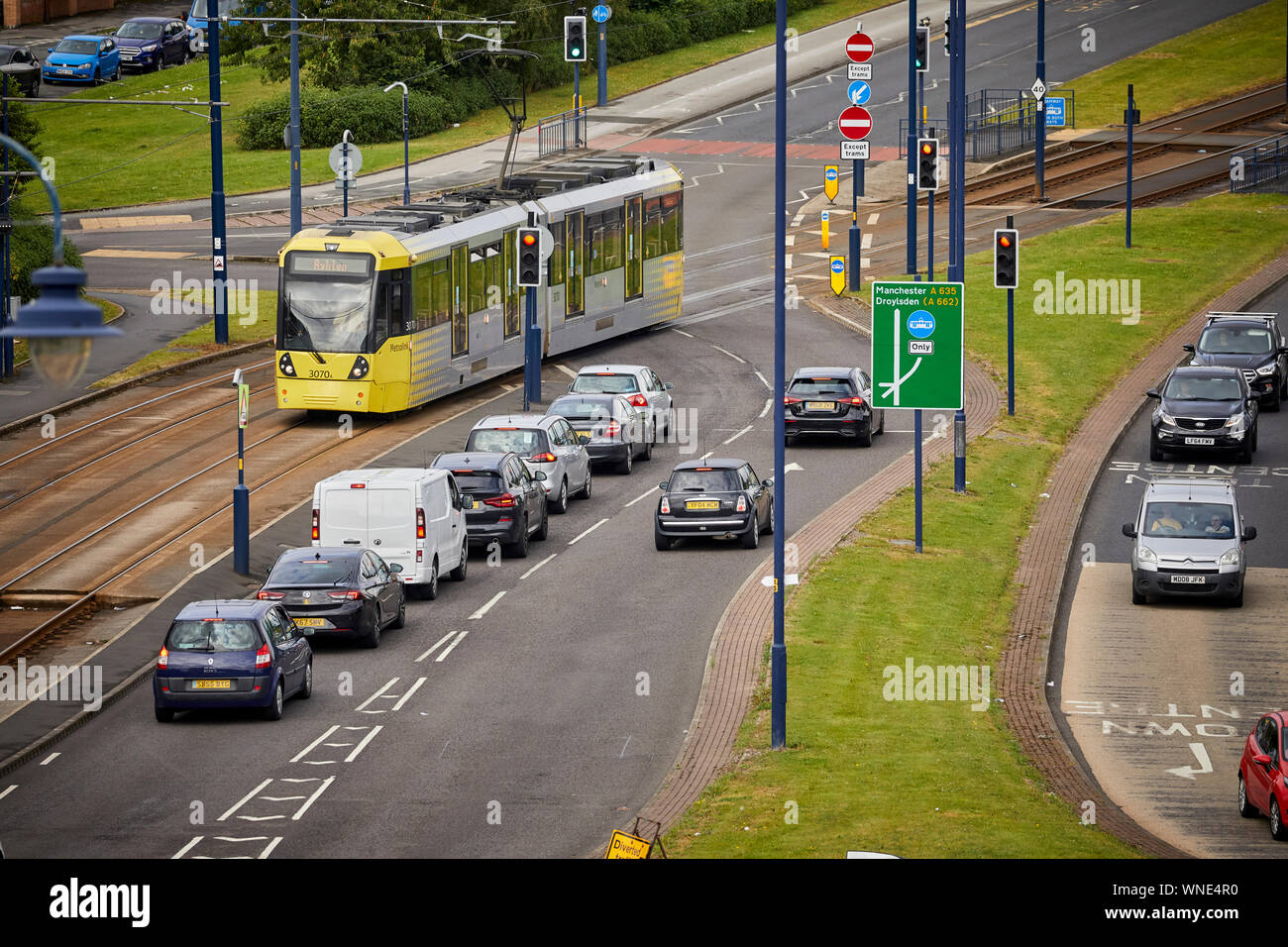 Metrolink tram lines crossing a road  in Ashton-under-Lyne Stock Photo