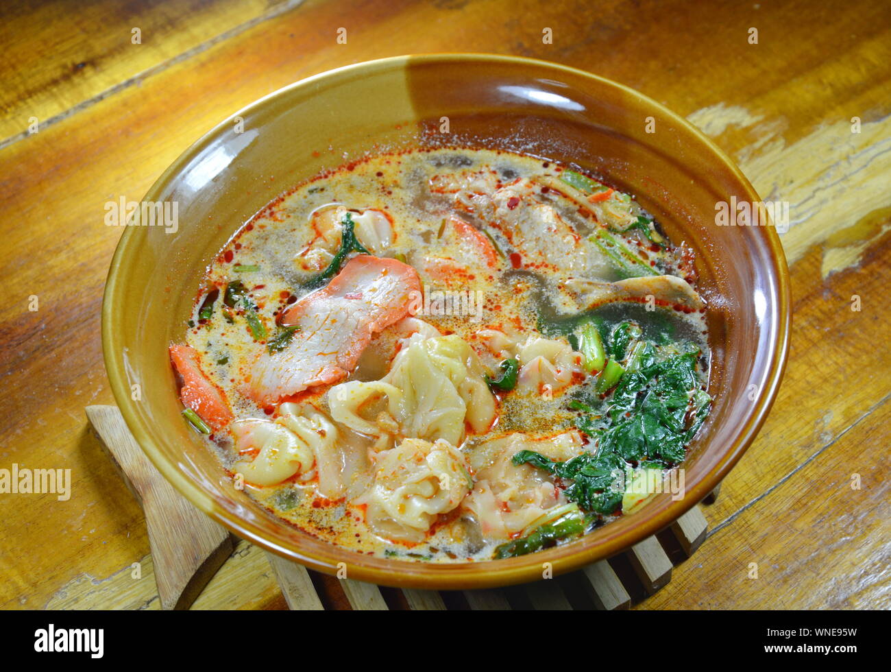 Chinese pork dumpling in Tom Yum soup Stock Photo - Alamy