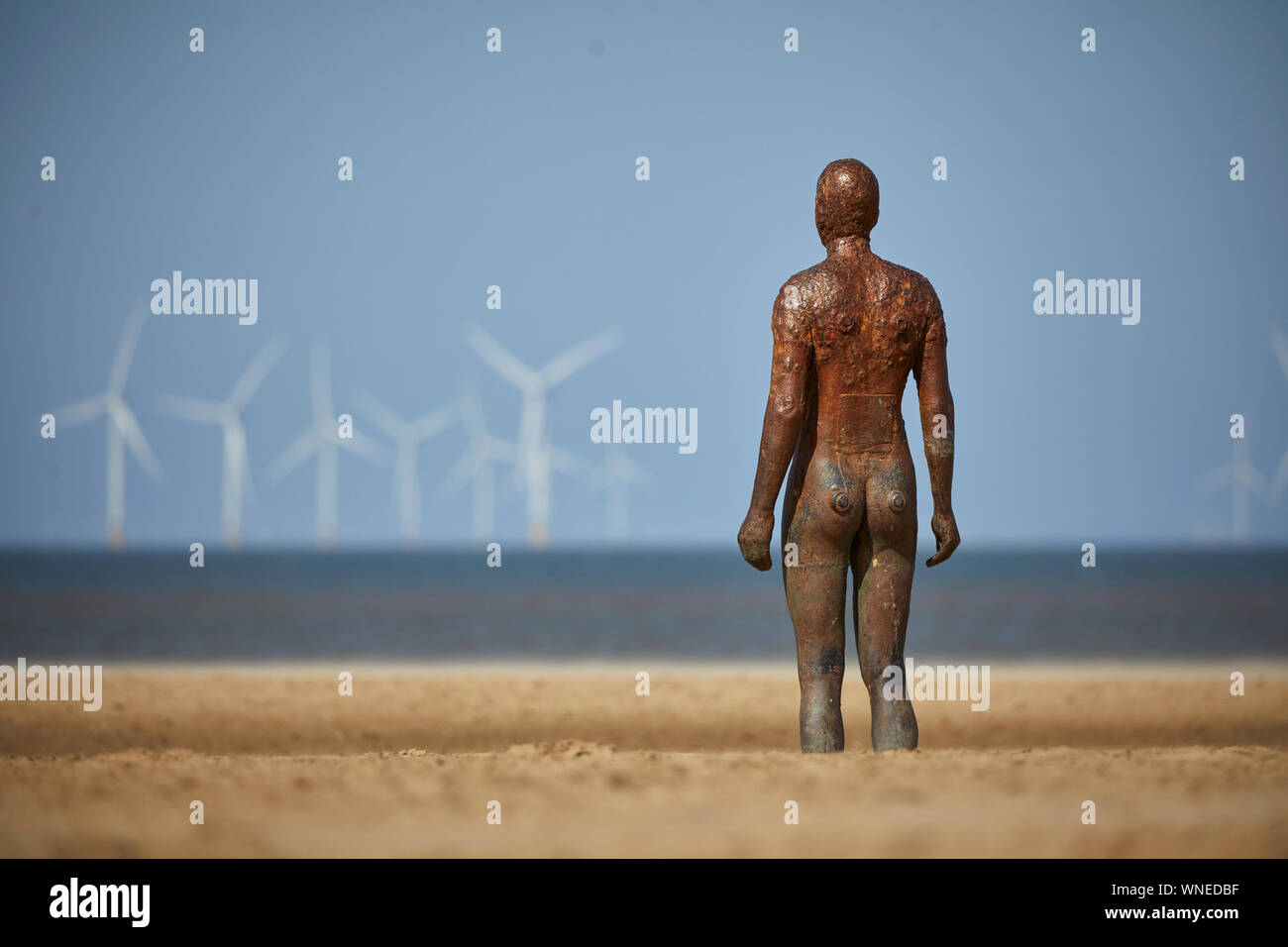 Statue, Another Place by Anthony Gormley Crosby Beach River Mersey estuary Sefton, Merseyside, England. Stock Photo