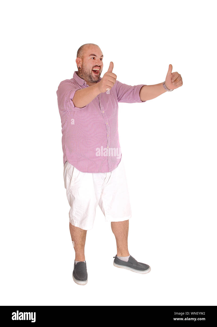 A Hispanic man standing in white shots and a striped shirt stretched  out his arm with thumps up, isolated for white background Stock Photo