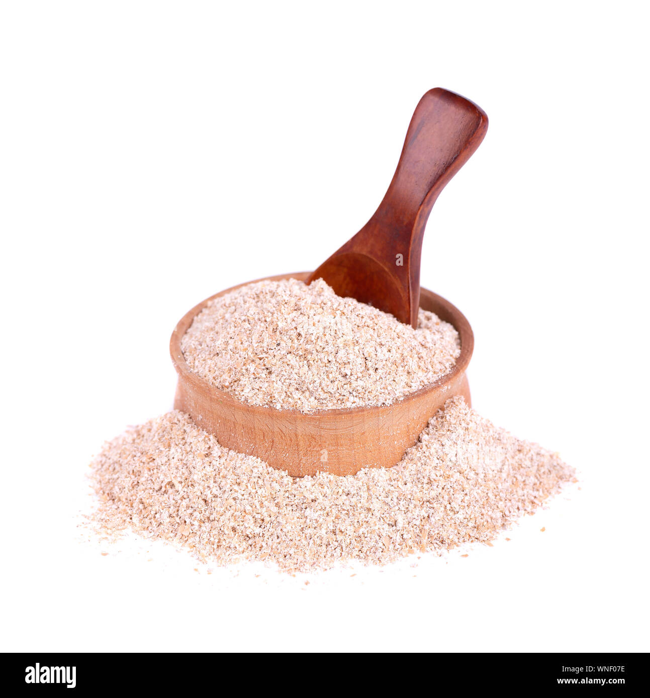 Wheat bran in a small wooden bowl, isolated on white. Wheat germ, the