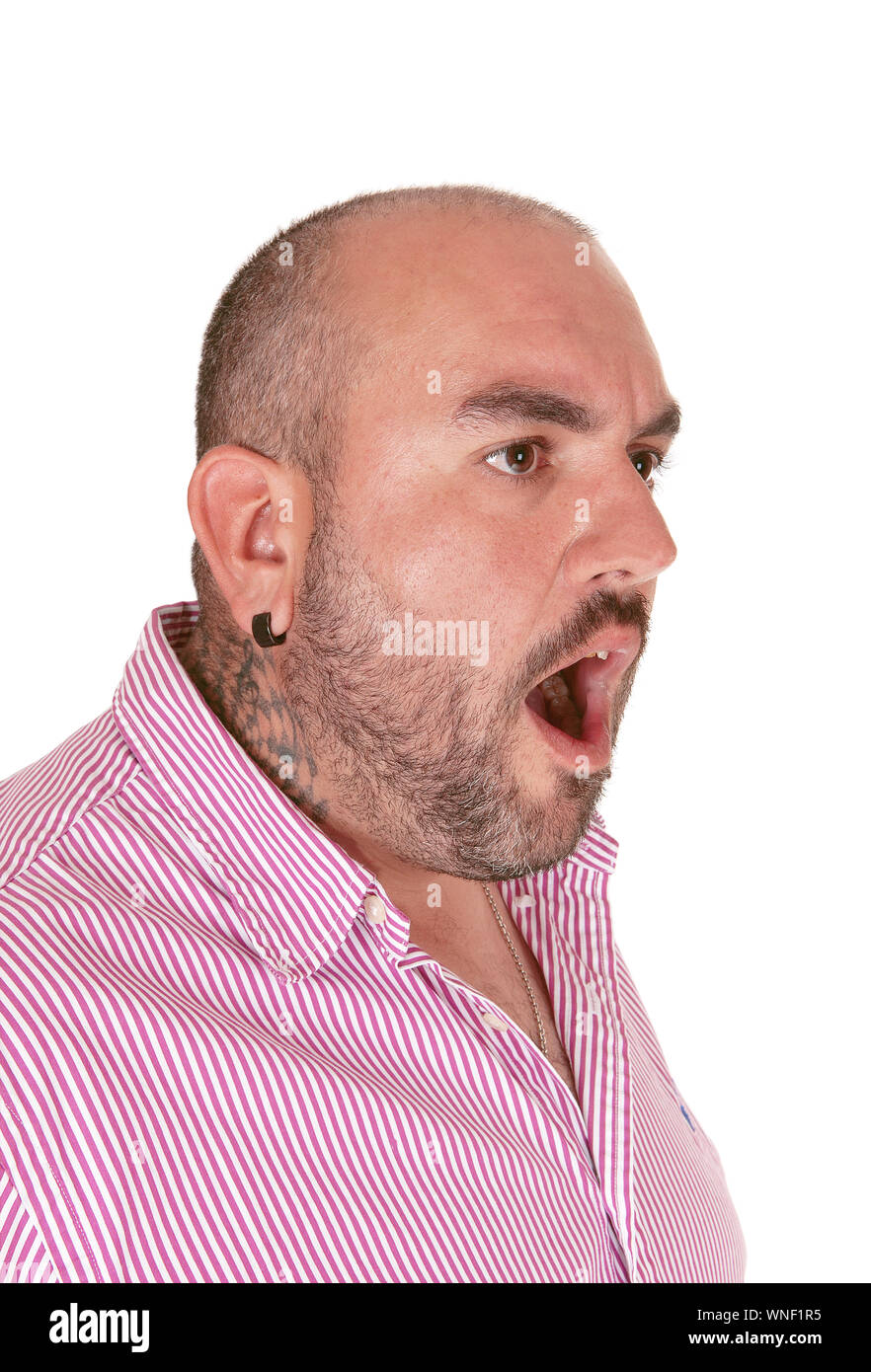 A very angry middle age Hispanic man in a red shirt shouting with his ...