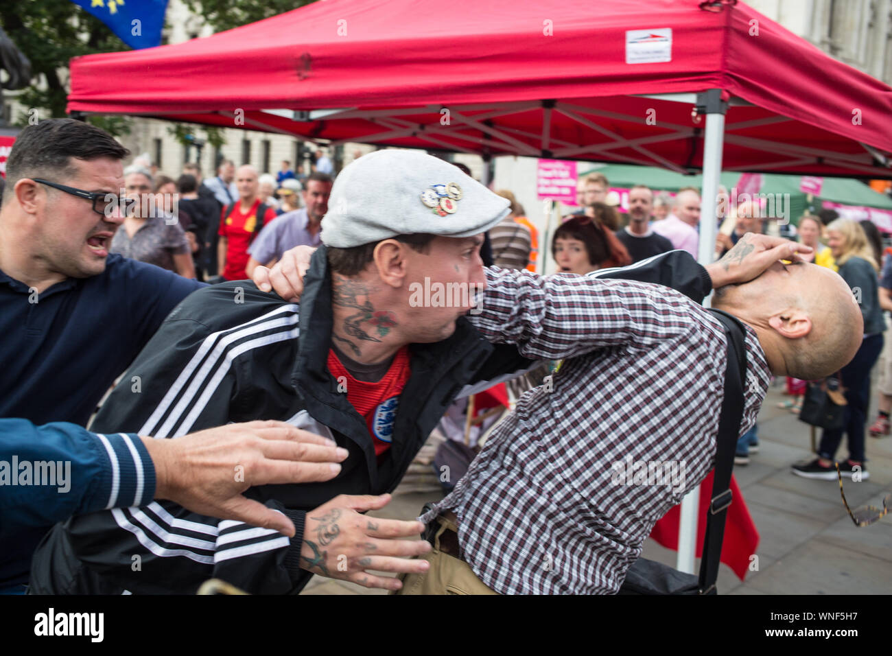 London UK 3rd Sep 2019 Pro and anti Brexit clash as MPs return to Parliament after summer recess in London. A man is attacked by a far right protester as violent clashes take place at End racist Environment rally in Parliament square. Stock Photo
