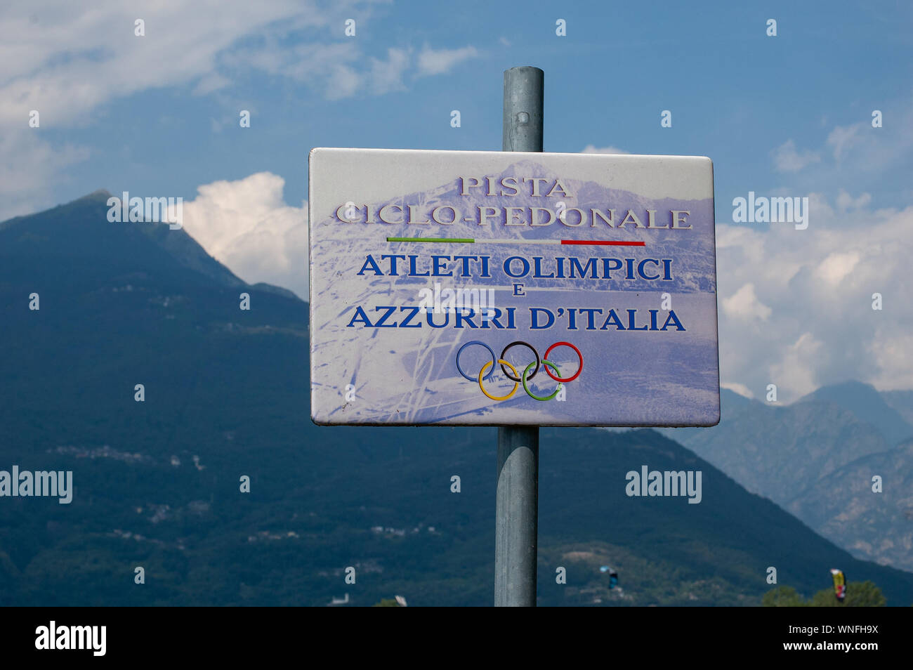 Lake Como, Italy - July 21, 2019. Bicycle and Walking Path Sign. Olympic and Italian athletes from Italy. Alp mountains on background Stock Photo
