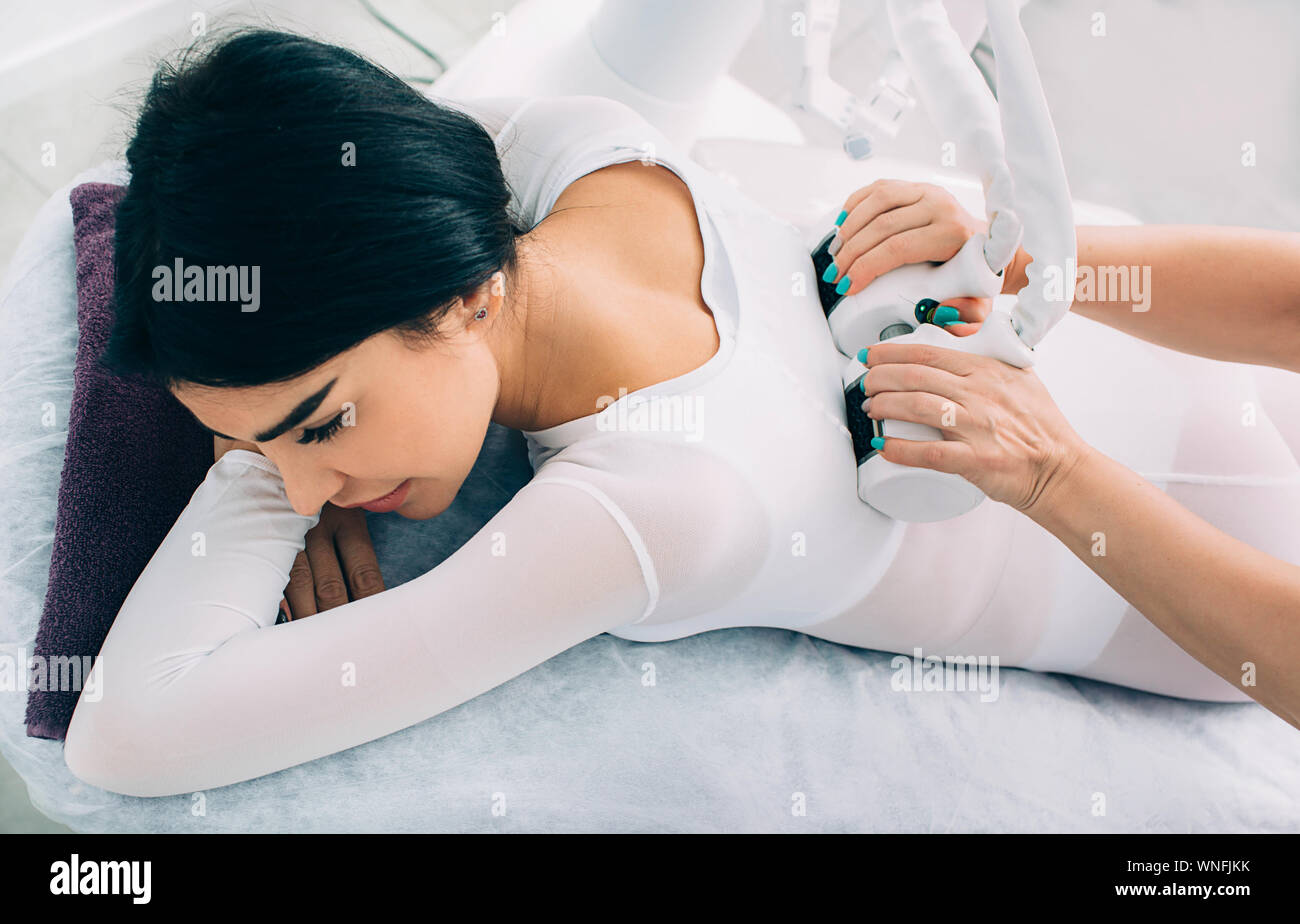 making slim body with the anti-cellulite LPG massage. woman dressed in a special suit getting a cellulite removal massage Stock Photo
