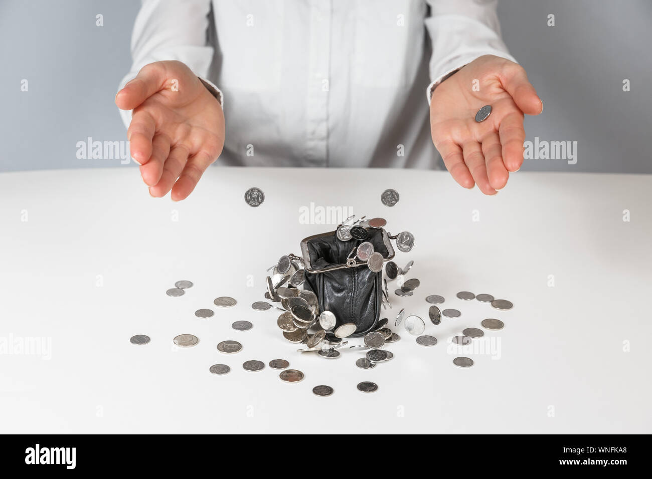 Money falling out of purse hires stock photography and images Alamy