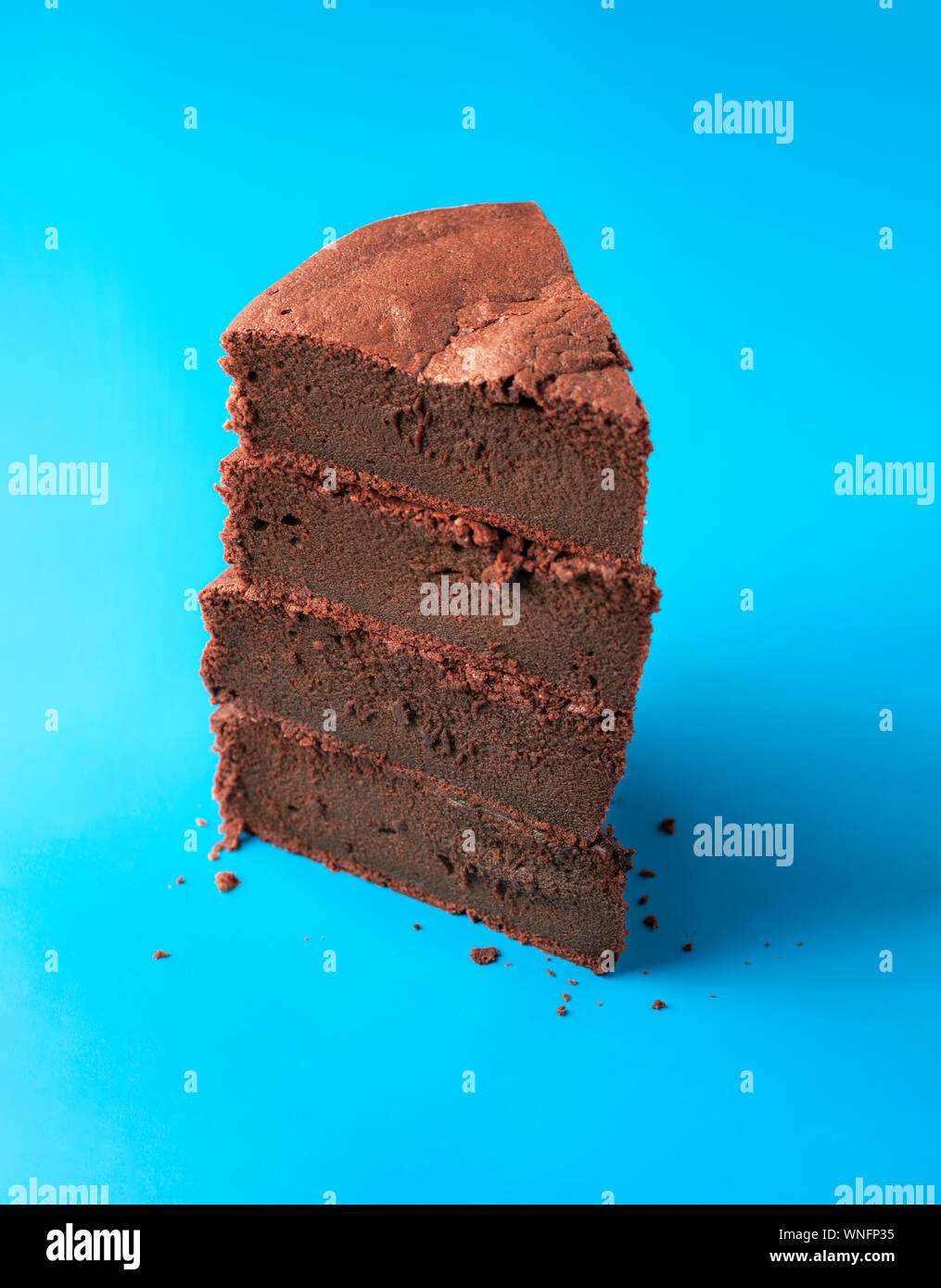 Brownie cake slice tower on a blue background. Kladdkaka Fika cake